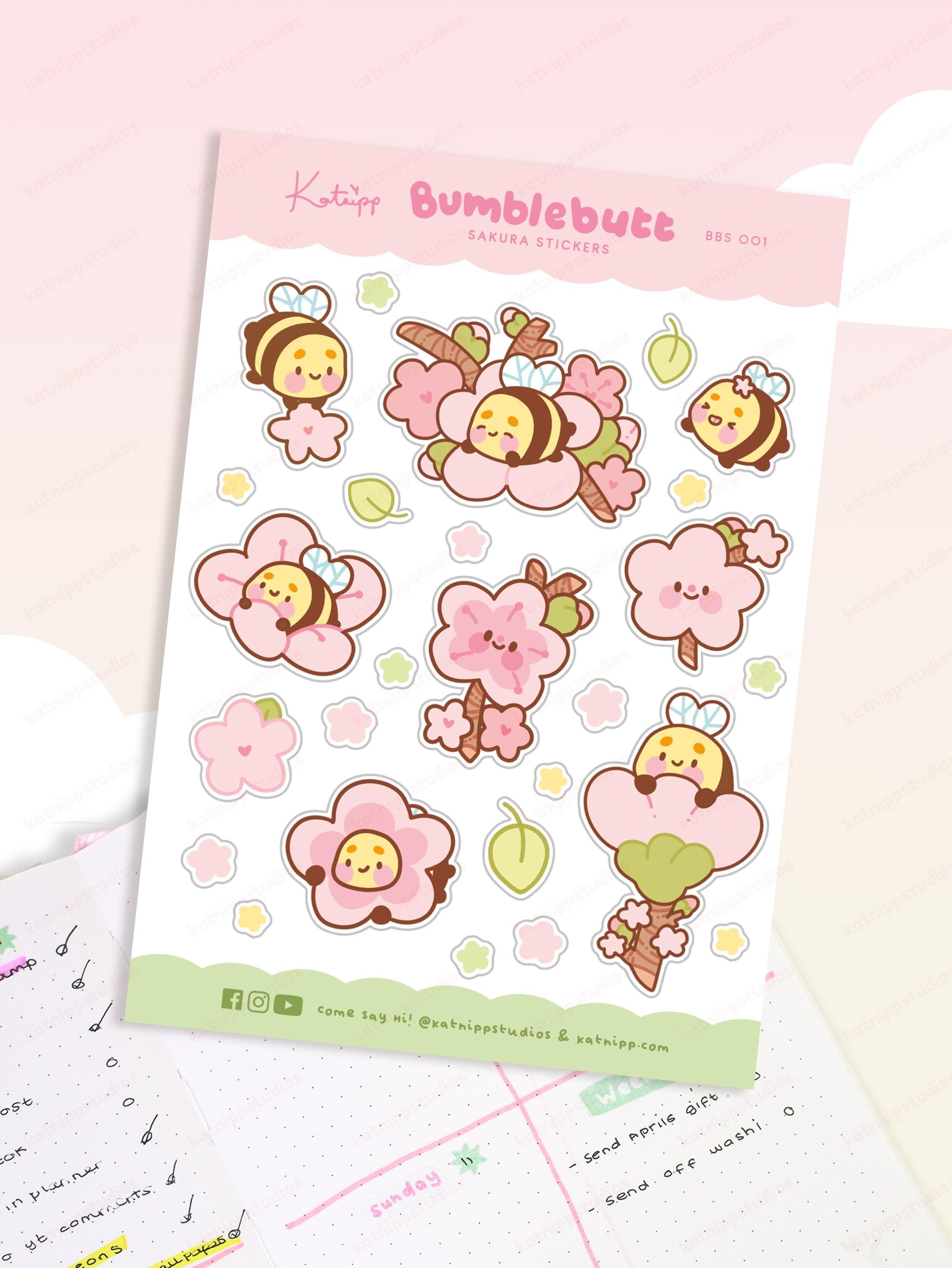 Image of Bumblebutt Sakura planner sticker sheet featuring cute bumblebee surrounded by pink cherry blossoms on vibrant A6 premium paper.