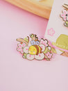 Enamel pin featuring Bumblebutt resting on a blossom branch, part of the Sakura Collection from Katnipp. 13