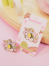 Enamel pin featuring Bumblebutt resting on a blossom branch, part of the Sakura Collection from Katnipp. 2