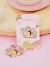 Enamel pin featuring Bumblebutt resting on a blossom branch, part of the Sakura Collection from Katnipp. 8
