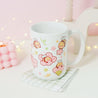 Adorable Bumblebutt Cherry Blossom Mug - Hand-printed white ceramic mug featuring a cute Bumblebutt design surrounded by cherry blossoms. 10