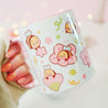 Adorable Bumblebutt Cherry Blossom Mug - Hand-printed white ceramic mug featuring a cute Bumblebutt design surrounded by cherry blossoms. 13