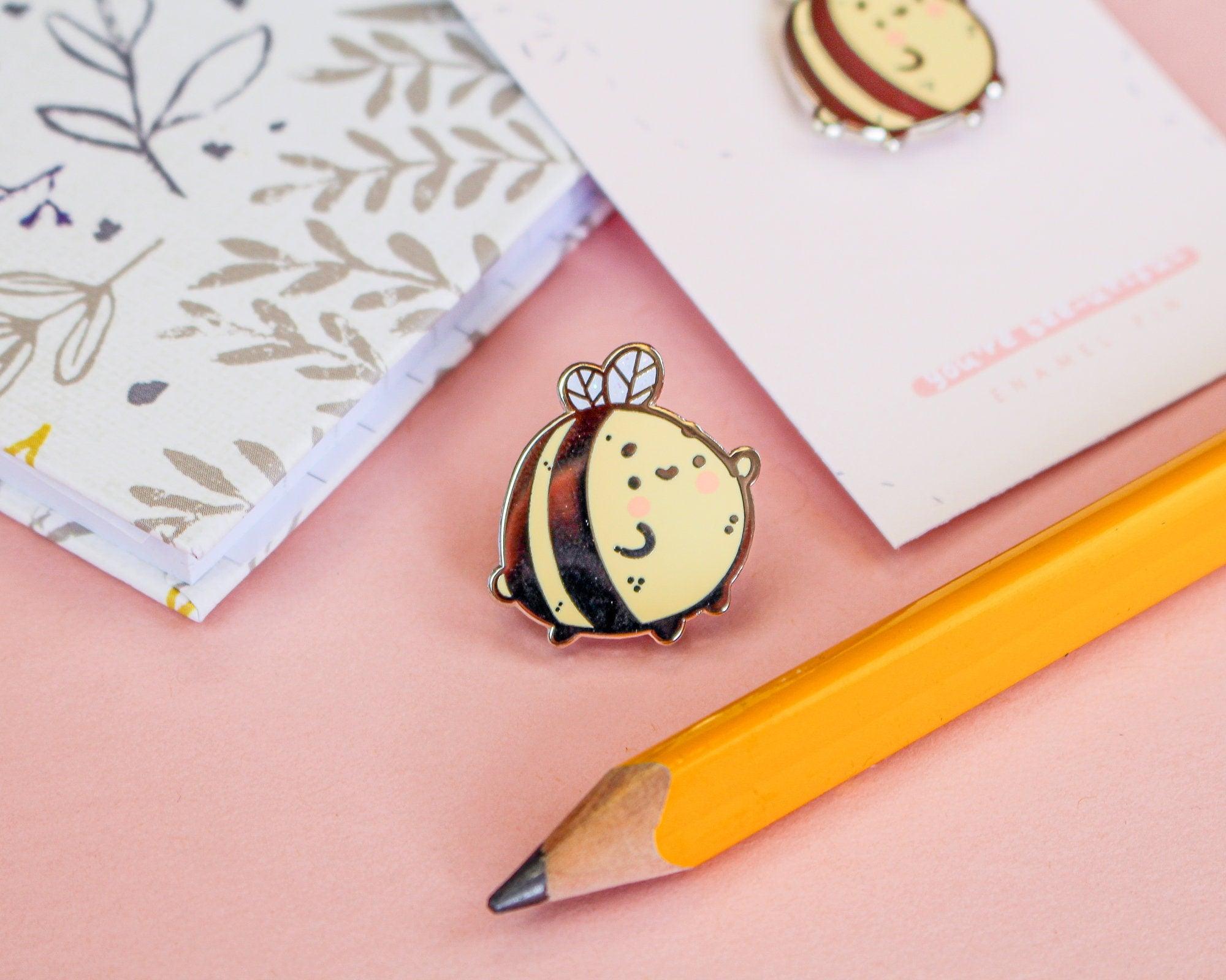 Enamel pin featuring a cute bumble bee design, perfect for jackets, bags, and clothing.