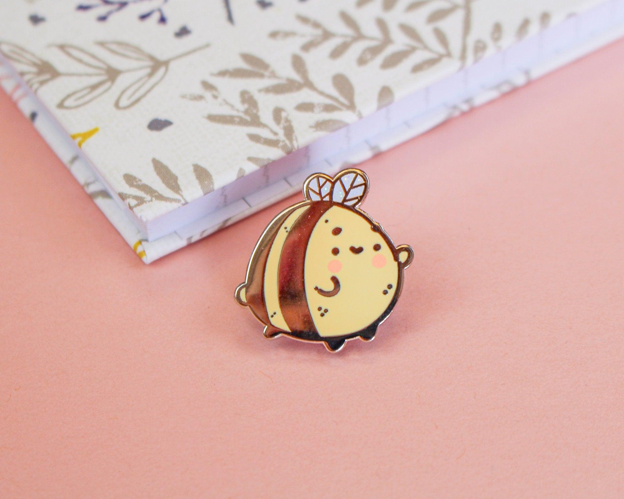 Enamel pin featuring a cute bumble bee design, perfect for jackets, bags, and clothing. 2